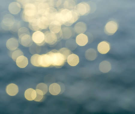 bokeh of sun light reflection on a water surface