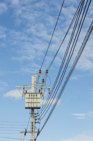 Transformer on Electricity post, high power station. High voltage with blue sky