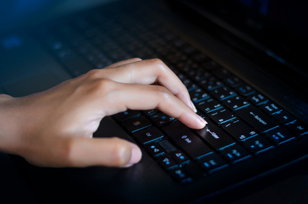 Press enter button on the computer. business Communication network World map send message Connect worldwide hand keyboardの写真素材