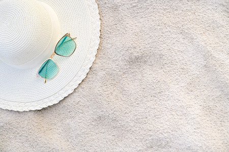 Hats and glasses are located on the sea blue sea beaches on a clear dayの写真素材