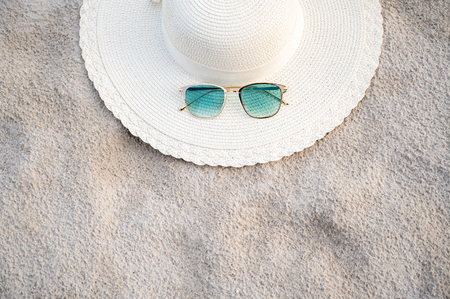 Hats and glasses are located on the sea blue sea beaches on a clear dayの写真素材