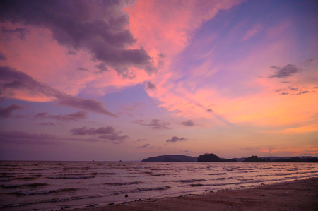 Sea beach in the evening yellow sky pinkの写真素材