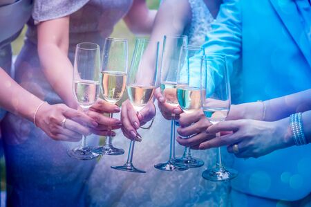 A group of young women are bumping into the glass to celebrate.の写真素材