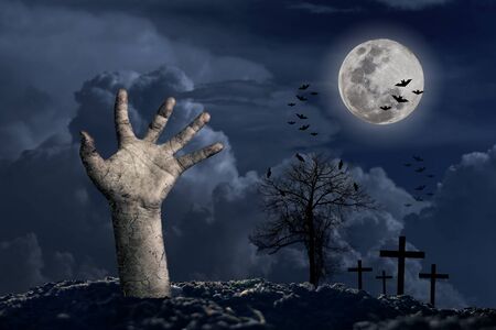 Halloween Holidays calabash hand in front of the big moon with a cloud below In the night with a star full of blueの写真素材