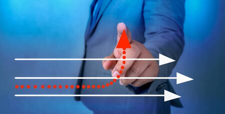 business different direction The hand of a business man is pointing to a business change pointの写真素材