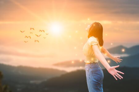 Freedom And Healthy a girl stretching her arms in the sunの写真素材