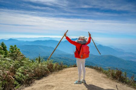 Young people walking on a hilltop in Doi Inthanon, Chiang Mai, Thailandの写真素材