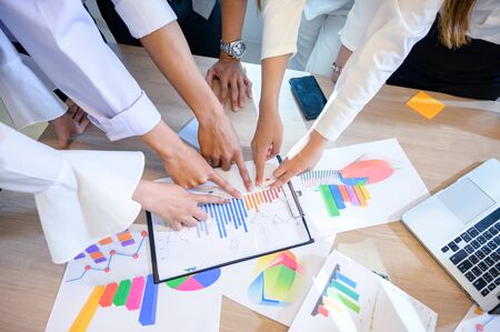 Business people are meeting and graphing business growth on a deskの写真素材