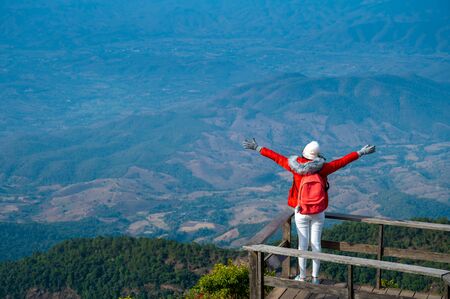 Young people walking on a hilltop in Doi Inthanon, Chiang Mai, Thailandの写真素材
