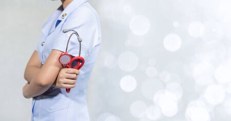 Female doctor with tools, white backgroundの写真素材