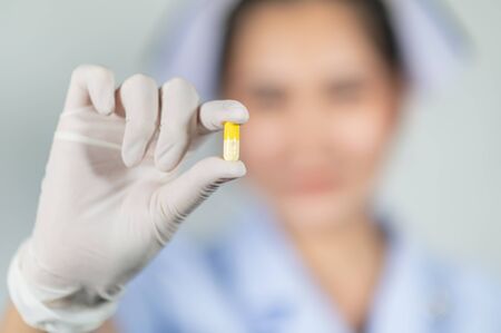 The doctor is holding the medicine in his handの写真素材