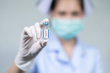 The doctor put on a mask and was injecting with coronavirus covid-19.の写真素材