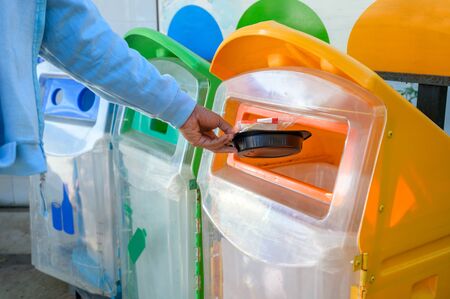 People are throwing rubbish into the trash to separate the rubbish.の写真素材