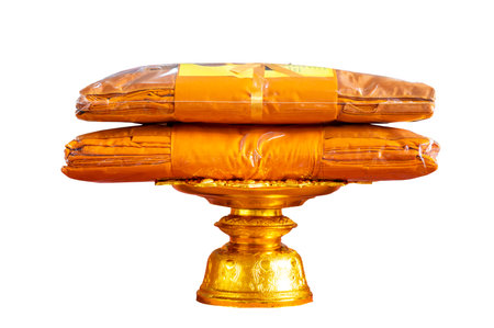 set of monk's robes placed on a pedestal on a white background isolateの写真素材