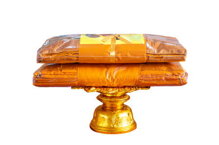 set of monk's robes placed on a pedestal on a white background isolateの写真素材