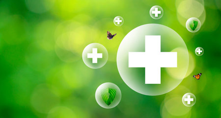 Plus symbol in balloon bubbles on natural green background.の写真素材