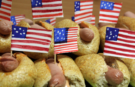 American hot dogs with small American flags close plan, bun and sausageの写真素材