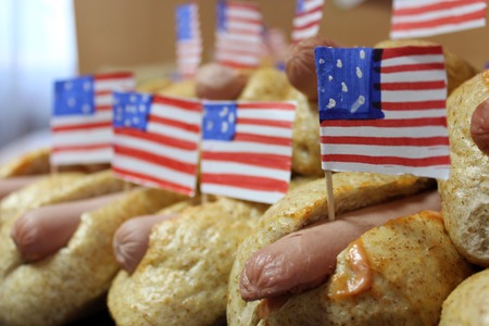 American hot dogs with small American flags close plan, bun and sausageの写真素材