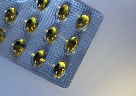 Packing fish oil on a white background isolate vitaminsの写真素材