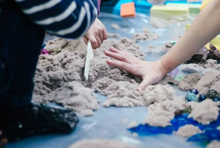 Sand therapy. Photo of hands with sand