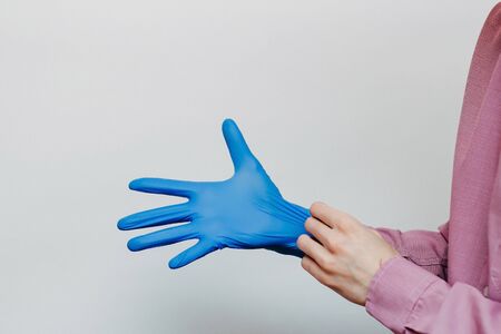 The guy puts on medical gloves