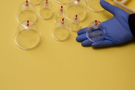 Jars for hijama. Vacuum pumps on a yellow backgroundの写真素材