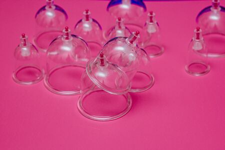 Jars for hijama. Vacuum pumps on a pink backgroundの写真素材