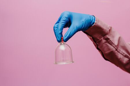 Vacuum pumps and jars for hijama. Arms. On a pink backgroundの写真素材