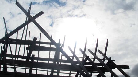 The roof of the house which is being built. Boards. Triangular roof against the sky. Building content.の写真素材