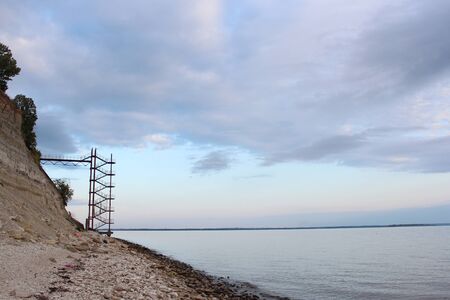 Sea shore. Hill and high stairs to the pier.の写真素材