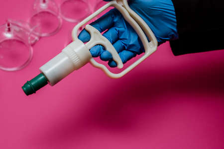 Vacuum pumps and jars for hijama. Arms. On a pink backgroundの写真素材