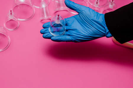 Vacuum pumps and jars for hijama. Arms. On a pink backgroundの写真素材