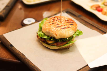 Burgers with lettuce, cutlet and tomatoes. Burgers in the restaurant. Burgers close up. Fast food,...