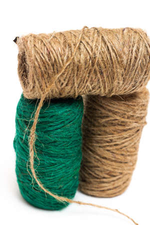 Three skeins of twine. Twine The twine is brown and green. On a white background, stringの写真素材