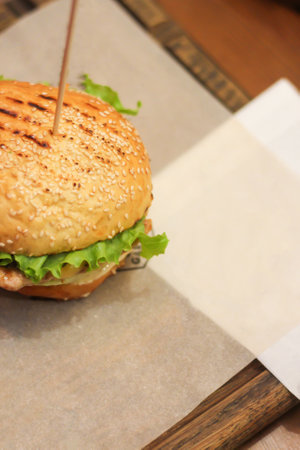 Burgers with lettuce, cutlet and tomatoes. Burgers in the restaurant. Burgers close up. Fast food, wrong food. Fat. Obesityの写真素材