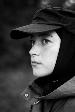 Fashionable Muslim woman in a black cap. Fashion industry. Face. Close up. Black and white photographyの写真素材