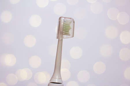 Electric toothbrush head with cap. Photo bokehの写真素材