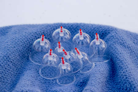 Jars for hijama on a knitted blue plaid in the snow in the forest. Vacuum therapy. Bloodletting according to the Sunnah. Chinese medicine.の写真素材
