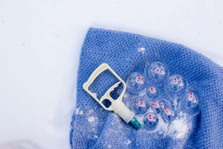 Jars for hijama on a knitted blue plaid in the snow in the forest. Vacuum therapy. Bloodletting according to the Sunnah. Chinese medicine.の写真素材