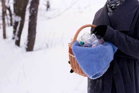 A woman in a gray coat holds a basket of hijama cans. Hijama jars and hijama pump, bloodletting,...