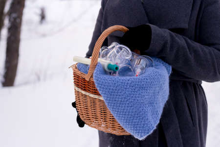 A woman in a gray coat holds a basket of hijama cans. Hijama jars and hijama pump, bloodletting, Chinese medicineの写真素材