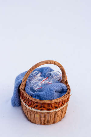 Jars for hijama in a basket in the snow. Wicker basket. Bloodletting according to the Sunnah. Vacuum therapy. medical and health concept. Winter and snow.の写真素材