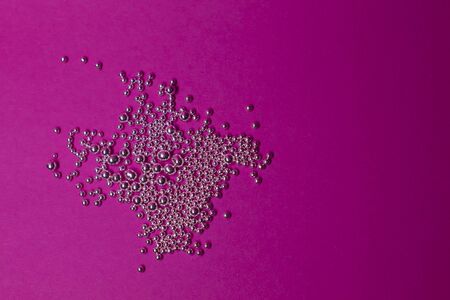 A lot of silver little balls on a pink background. Abstractの写真素材