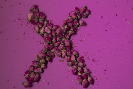 A lot of little pink roses on a pink background - X-shaped - horizontal photoの写真素材