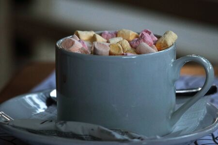A cup of cocoa with marshmallows on a table - horizontal photoの写真素材