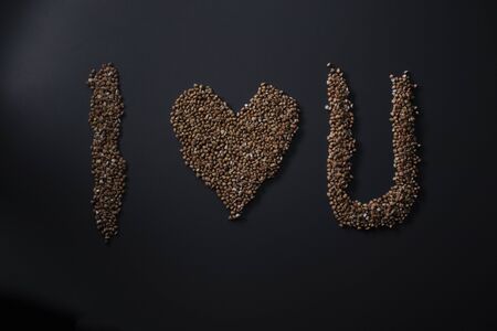 Words I LOVE YOU written with buckwheat On gray background, top view, copy space. Food supplies crisis, food donation on quarantine isolation period.の写真素材