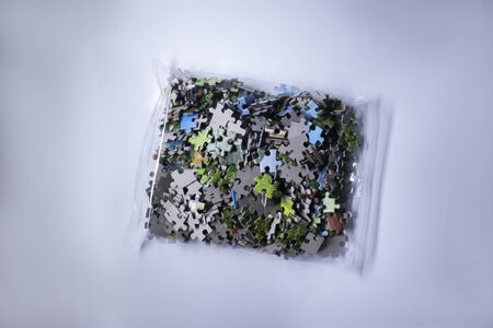 packing with multicoloured puzzles on a white background. isolated. High quality photoの写真素材