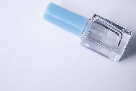 A bottle with blue nail polish on white background. nail lacquer. Nail manicure concept. Isolated, copy space. の写真素材