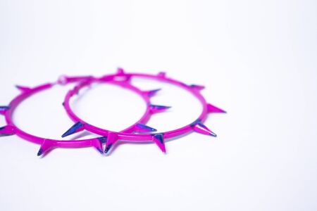 Pink and blue earrings with spikes. jewelry and accessories concept. Isolated, copy space. Macro...