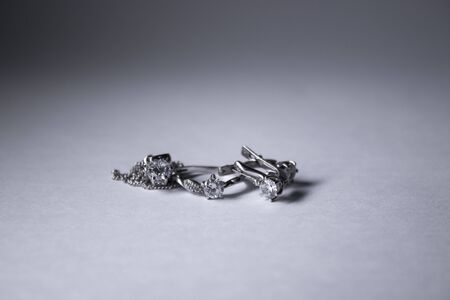 Expensive set of silver womens jewelry - ring, pendant and earrings. Isolated, copy space. Macro...